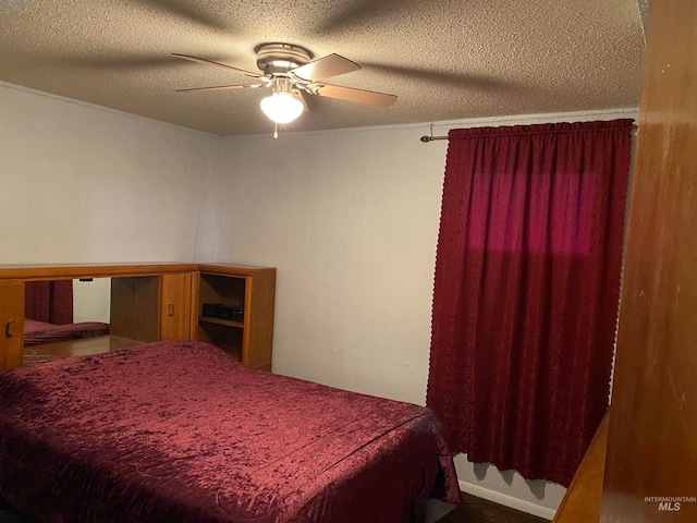 bedroom featuring a textured ceiling and ceiling fan