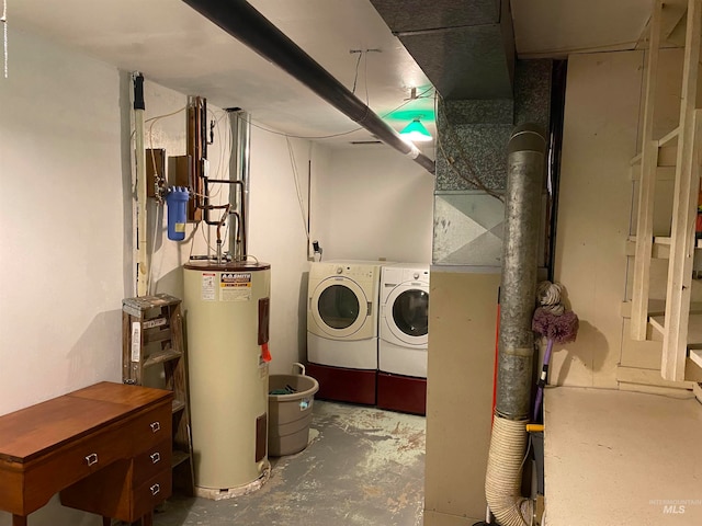 clothes washing area featuring water heater and washing machine and dryer