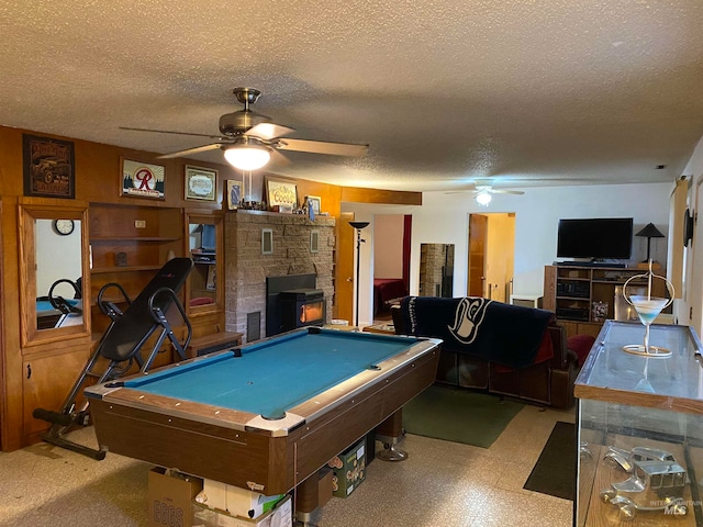 rec room with a textured ceiling, a fireplace, pool table, and ceiling fan