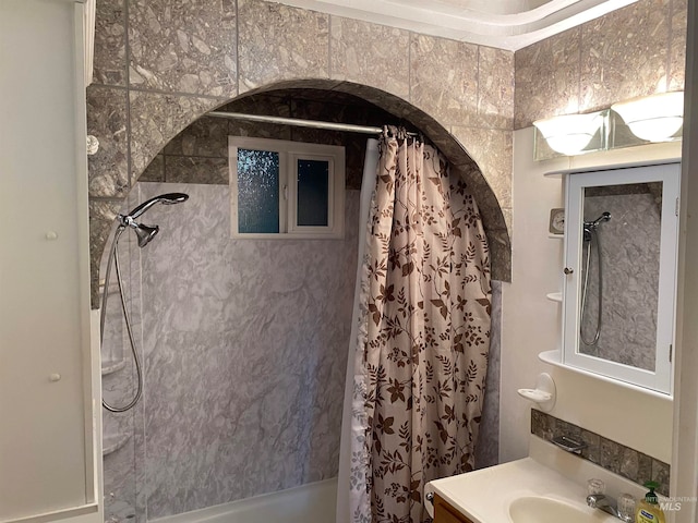 bathroom with shower / tub combo with curtain and vanity