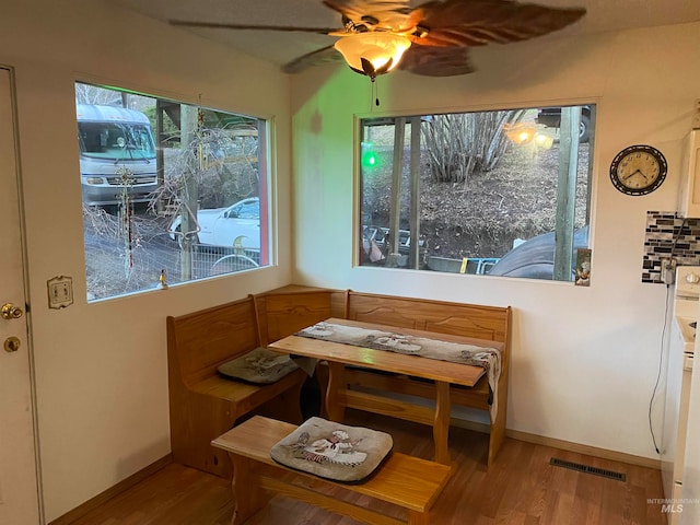 dining area featuring wood-type flooring and ceiling fan