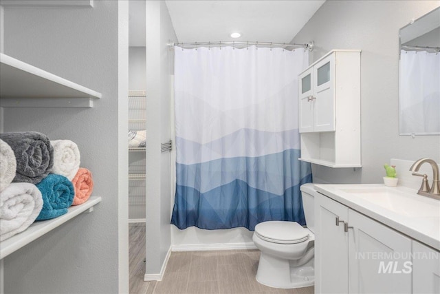 full bathroom with vanity, toilet, and shower / bath combo with shower curtain