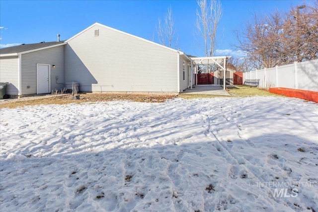 view of snow covered rear of property