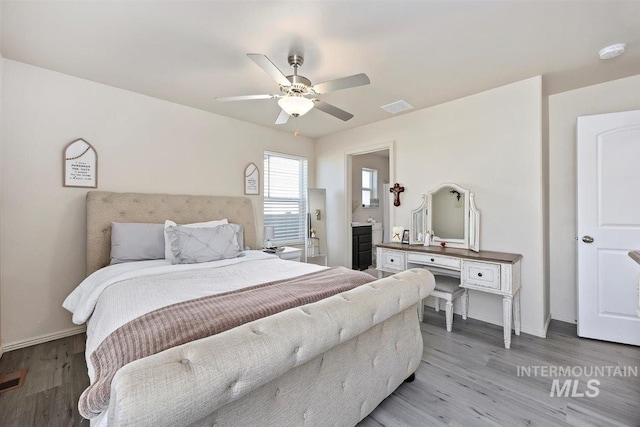 bedroom with baseboards, visible vents, and light wood-style floors