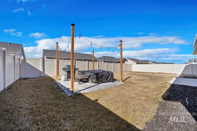 view of yard with a patio area and a fenced backyard