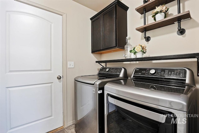 washroom featuring cabinet space and washer and dryer