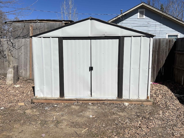 view of shed with fence