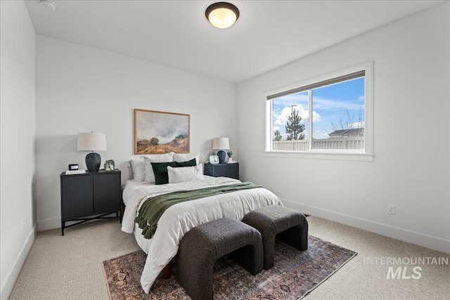 bedroom featuring carpet and baseboards