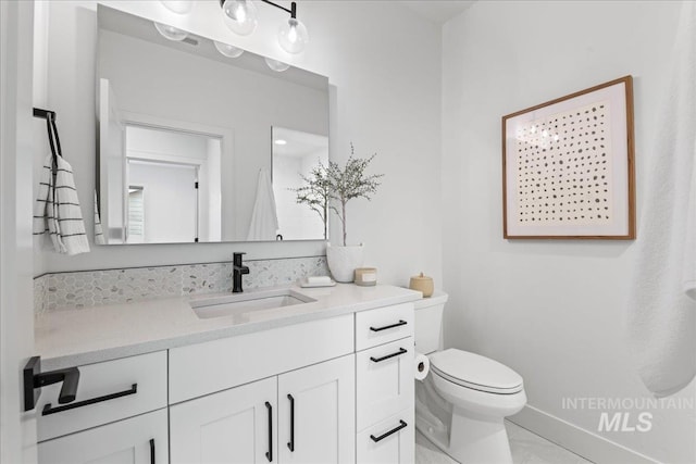 bathroom with toilet and vanity