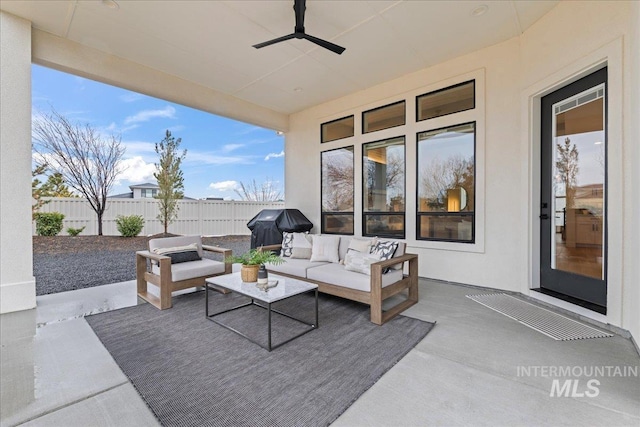 view of patio / terrace with a ceiling fan, a grill, fence, and an outdoor hangout area