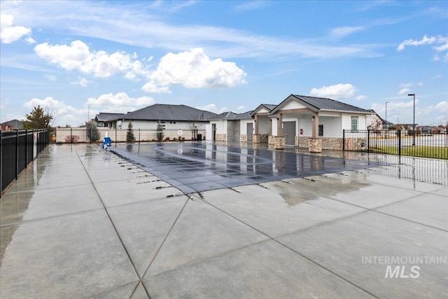 view of swimming pool featuring fence and a residential view