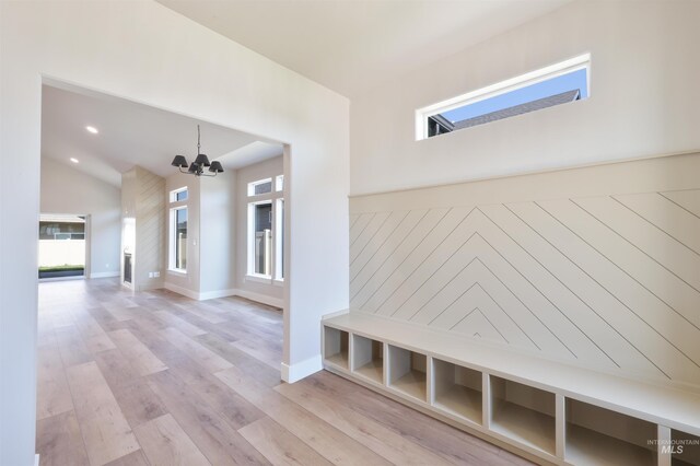 mudroom featuring baseboards, light wood-style flooring, an inviting chandelier, high vaulted ceiling, and recessed lighting