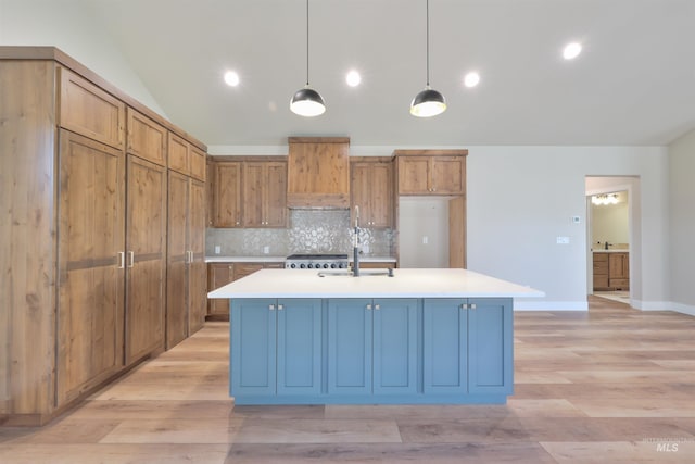 534 Falling Leaf Ln, Twin Falls, ID 83301 - kitchen featuring a sink, light countertops, tasteful backsplash, decorative light fixtures, and lofted ceiling
