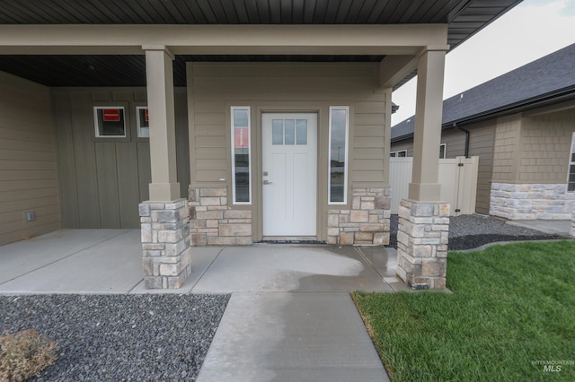 doorway to property featuring a lawn