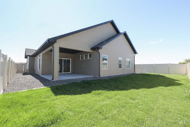 rear view of property with a patio area, a fenced backyard, and a lawn