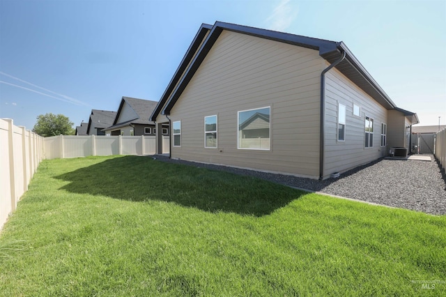 back of house with a yard, a fenced backyard, and central air condition unit