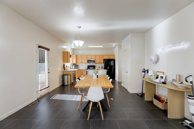 tiled dining space featuring sink