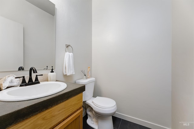 bathroom with vanity, toilet, and tile patterned flooring