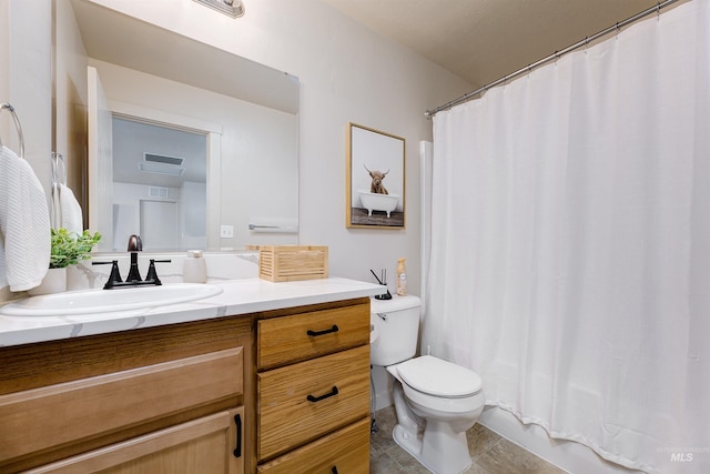 bathroom featuring vanity, tile patterned floors, and toilet