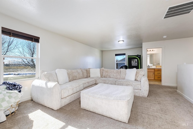 living room with a wealth of natural light and light colored carpet