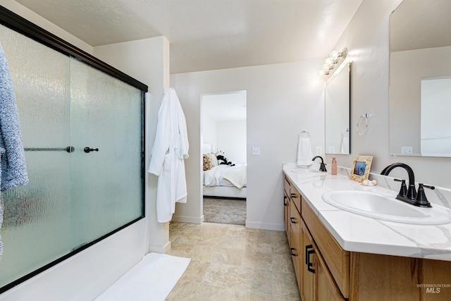 bathroom with vanity and a shower with door