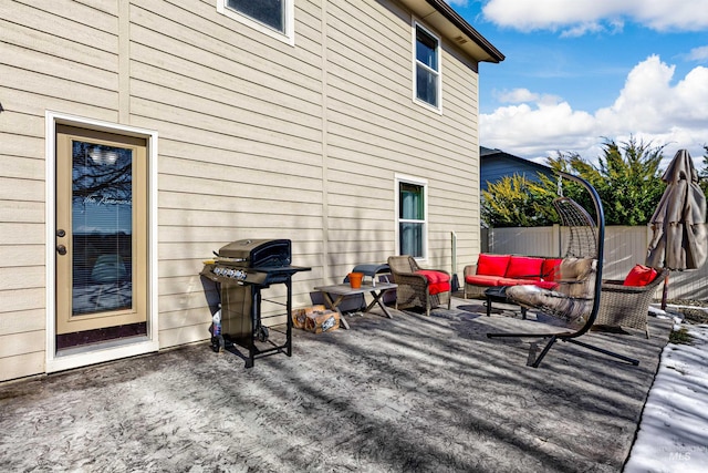 wooden deck featuring a grill, an outdoor living space, and a patio