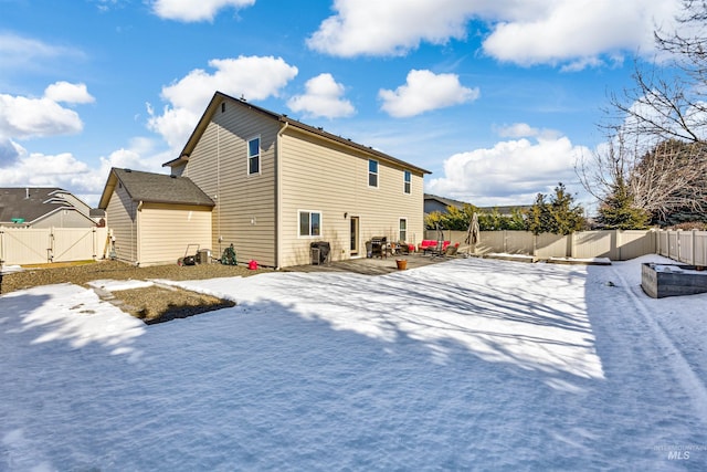 view of snow covered rear of property