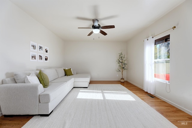 living room with hardwood / wood-style floors and ceiling fan