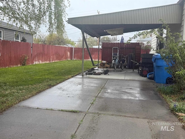 view of patio with a fenced backyard and a carport