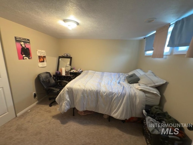 carpeted bedroom with a textured ceiling