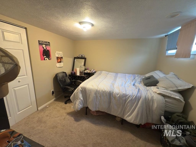 carpeted bedroom featuring a textured ceiling
