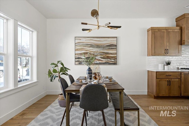 dining space featuring a notable chandelier and light hardwood / wood-style flooring