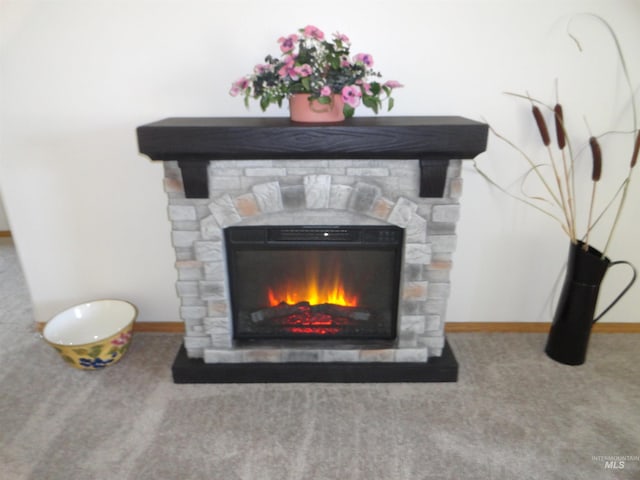 909 W Oakmont Ave, Nampa, ID 83686 - detailed view of a stone fireplace, carpet floors, and baseboards