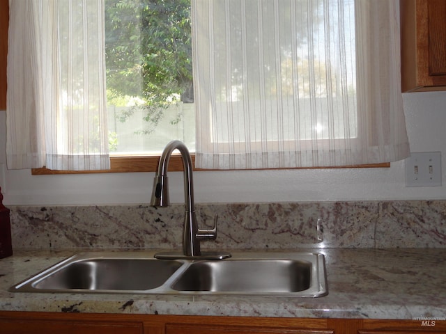 909 W Oakmont Ave, Nampa, ID 83686 - kitchen view of a sink, light countertops, and brown cabinetry