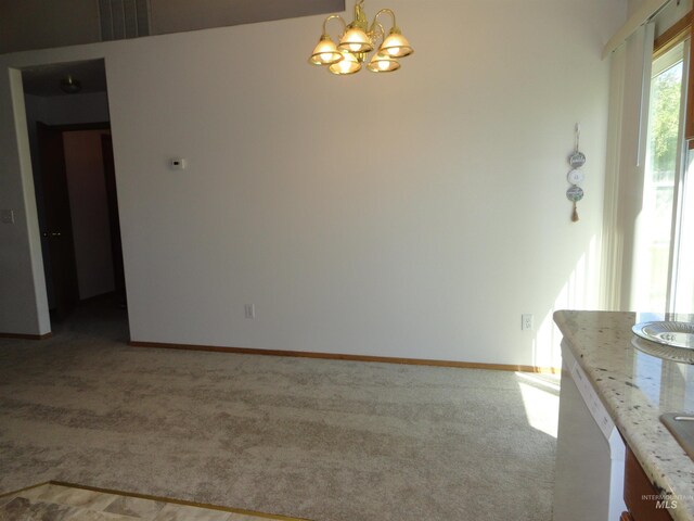 909 W Oakmont Ave, Nampa, ID 83686 - unfurnished dining area with a chandelier, light colored carpet, and baseboards