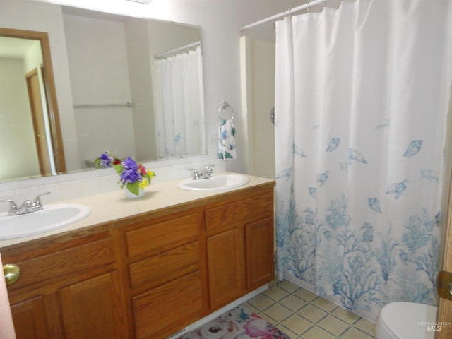 909 W Oakmont Ave, Nampa, ID 83686 - bathroom featuring tile patterned flooring, double vanity, toilet, and a shower with shower curtain