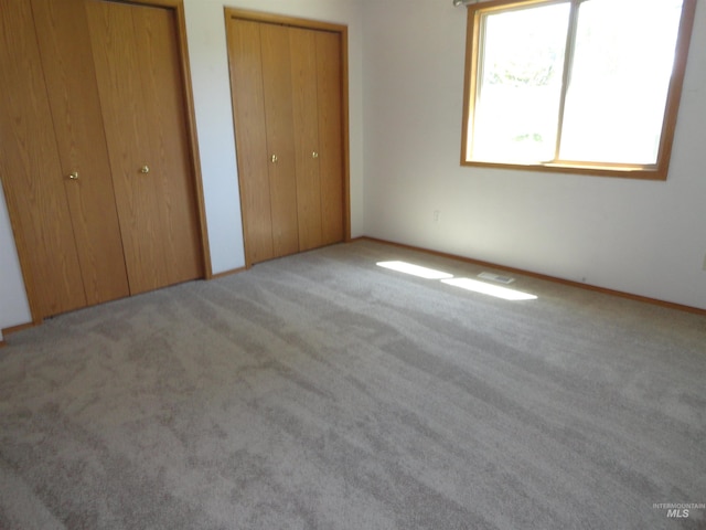 909 W Oakmont Ave, Nampa, ID 83686 - unfurnished bedroom featuring two closets and carpet