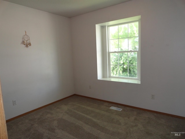 909 W Oakmont Ave, Nampa, ID 83686 - empty room featuring plenty of natural light, carpet flooring, and baseboards