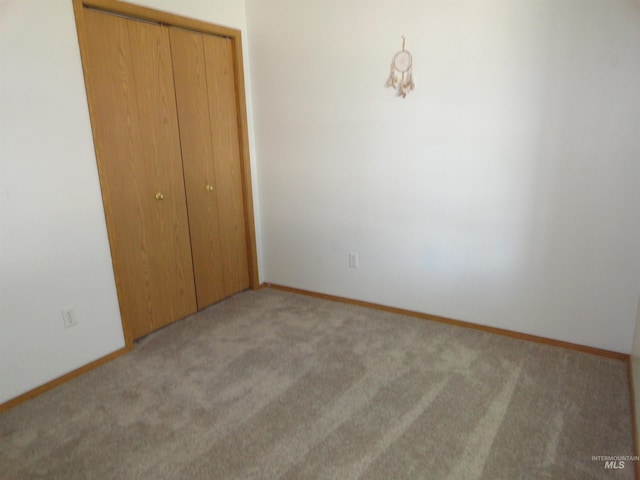 909 W Oakmont Ave, Nampa, ID 83686 - unfurnished bedroom featuring light colored carpet, a closet, and baseboards