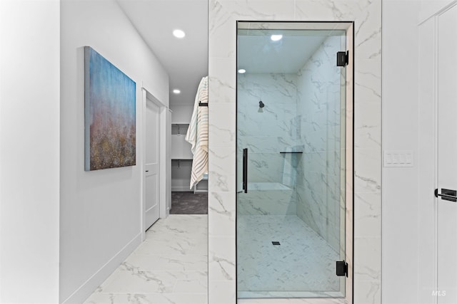 bathroom featuring a shower with door and tile floors