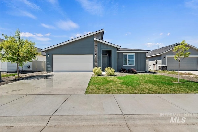 6501 S Faithful Ave, Meridian, ID 83642 - mid-century home featuring board and batten siding, an attached garage, driveway, and a front yard