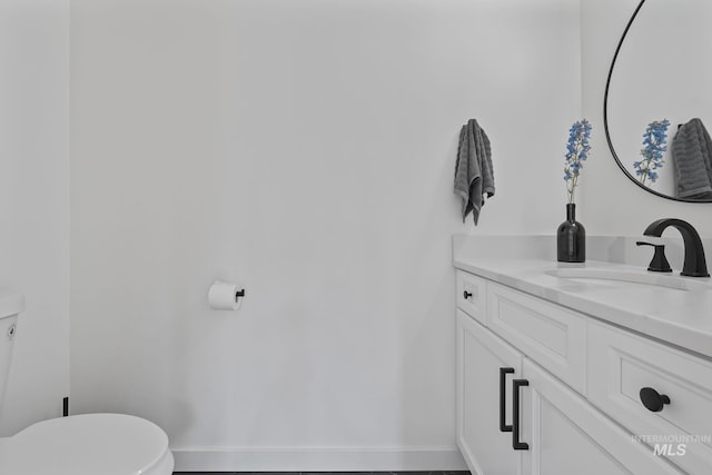 22168 Rio Vista Dr, Caldwell, ID 83607 - half bath featuring toilet, vanity, and baseboards