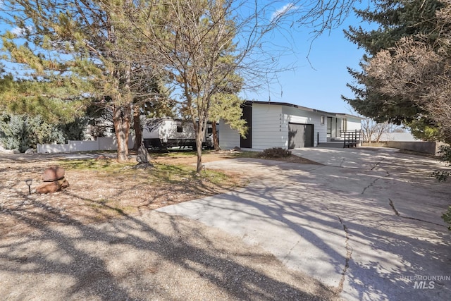 22168 Rio Vista Dr, Caldwell, ID 83607 - view of front of house with concrete driveway, a garage, and fence