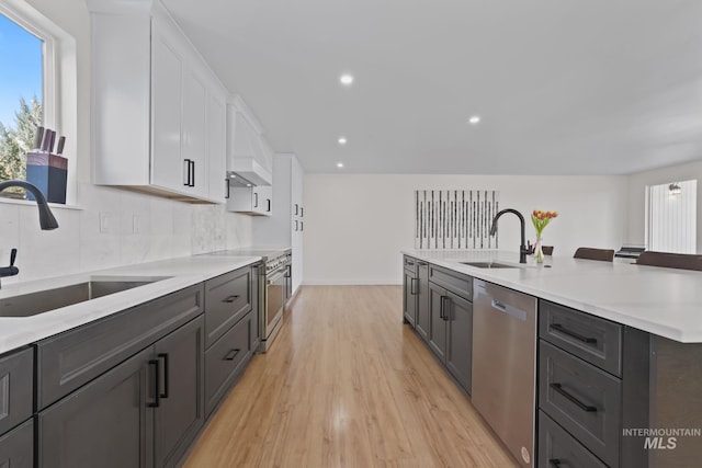 22168 Rio Vista Dr, Caldwell, ID 83607 - kitchen featuring white cabinetry, light countertops, appliances with stainless steel finishes, and a sink