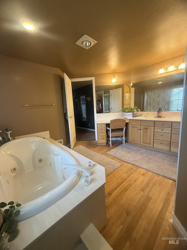 1351 Poplar, Twin Falls, ID 83301 - bathroom featuring vanity, a tub with jets, and wood finished floors