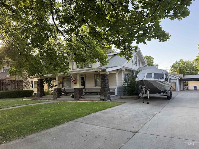 1351 Poplar, Twin Falls, ID 83301 - obstructed view of property with covered porch, a front lawn, and a garage