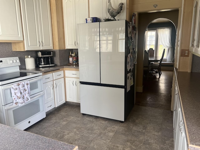 1351 Poplar, Twin Falls, ID 83301 - kitchen featuring white appliances, white cabinetry, dark countertops, and decorative backsplash