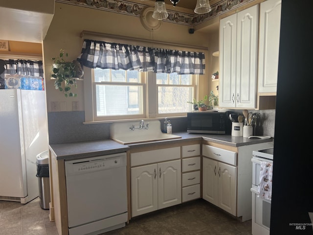 1351 Poplar, Twin Falls, ID 83301 - kitchen featuring white dishwasher, stove, white cabinetry, and freestanding refrigerator