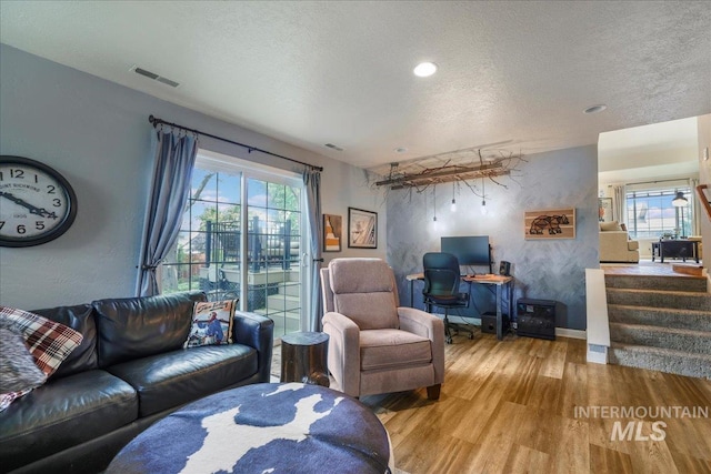 1037 Pahsimeroi Dr, Twin Falls, ID 83301 - living area featuring wood finished floors, a textured ceiling, stairway, an office area, and baseboards
