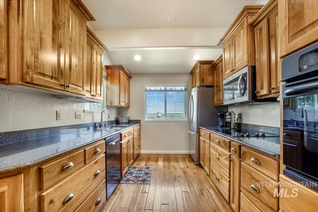 1037 Pahsimeroi Dr, Twin Falls, ID 83301 - kitchen with black appliances, a sink, brown cabinetry, and light wood-type flooring